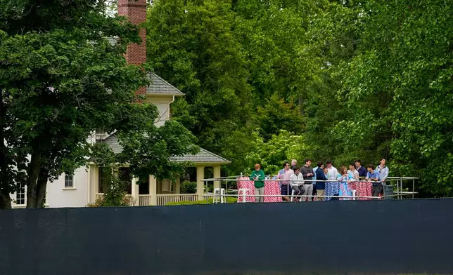 Fans watch from outside the fence line along the first fairway during the second round of the PGA Championship golf tournament at Aronimink Golf Club, Friday, May 15, 2026, in Newtown Square, PA. (AP Photo/Carolyn Kaster)