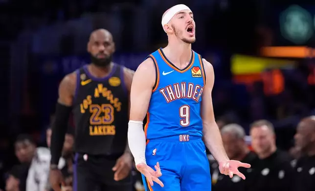 Oklahoma City Thunder guard Alex Caruso, celebrates after scoring as Los Angeles Lakers forward LeBron James stands behind during the first half of Game 4 in a second-round NBA basketball playoffs series Monday, May 11, 2026, in Los Angeles. (AP Photo/Mark J. Terrill)