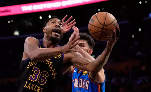 Los Angeles Lakers guard Marcus Smart, left, shoots as Oklahoma City Thunder center Chet Holmgren defends during the first half of Game 4 in a second-round NBA basketball playoffs series Monday, May 11, 2026, in Los Angeles. (AP Photo/Mark J. Terrill)