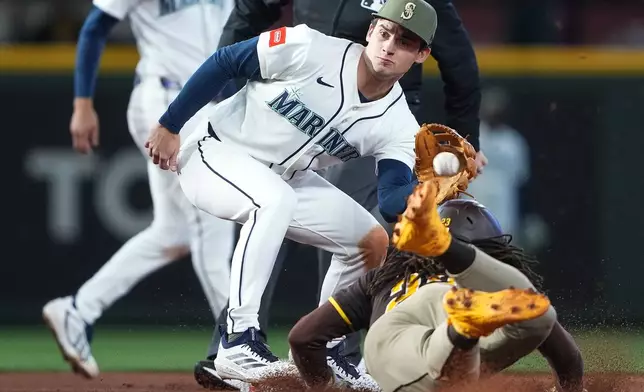Seattle Mariners second baseman Cole Young catches San Diego Padres' Fernando Tatis Jr. stealing second base during the eighth inning of a baseball game, Saturday, May 16, 2026, in Seattle. (AP Photo/Lindsey Wasson)