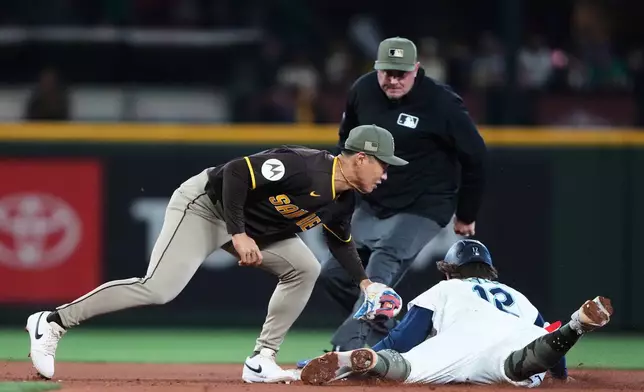 Seattle Mariners' Josh Naylor (12) steals second base in front of the tag from San Diego Padres second baseman Sung-Mun Song as Mariners' Julio Rodríguez steals third base during the eighth inning of a baseball game, Saturday, May 16, 2026, in Seattle. (AP Photo/Lindsey Wasson)