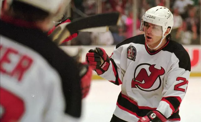 FILE - New Jersey Devils Claude Lemieux is greeted at the bench after scoring a goal in the first period of Game 3 of the NHL Stanley Cup Finals against the Detroit Redwings Thursday, June 22, 1995 at the Meadowlands in East Rutherford, N.J. (AP Photo/Bill Kostroun , File)