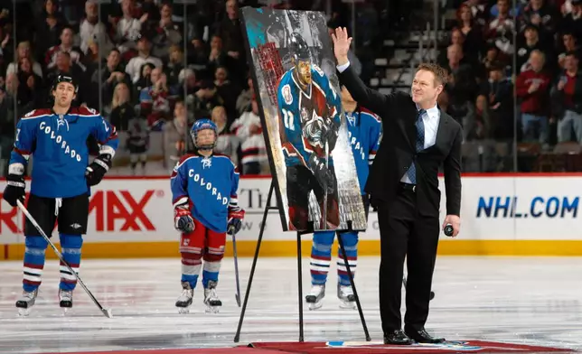 FILE - Retired Colorado Avalanche player Claude Lemieux waves to fans as he is honored for his years on the ice before the Avalanche host the New Jersey Devils in the first period of an NHL hockey game in Denver, Saturday, Jan. 16, 2010. (AP Photo/David Zalubowski, File)