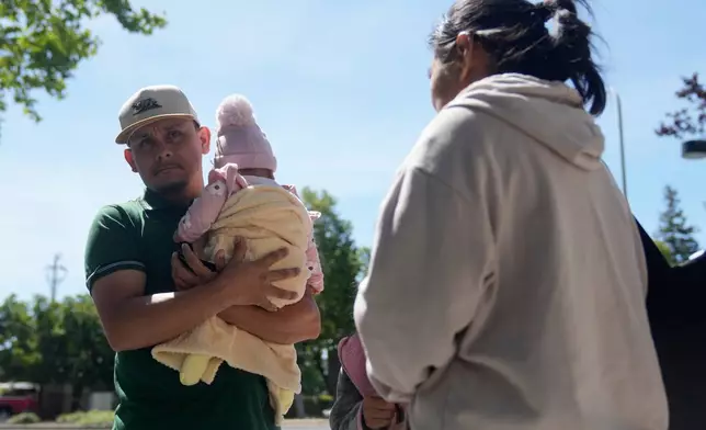 Oliverio Mora Huerta, left, is interviewed with his family before going to Immigration Court Tuesday, May 12, 2026, in Concord, Calif. (AP Photo/Jeff Chiu)