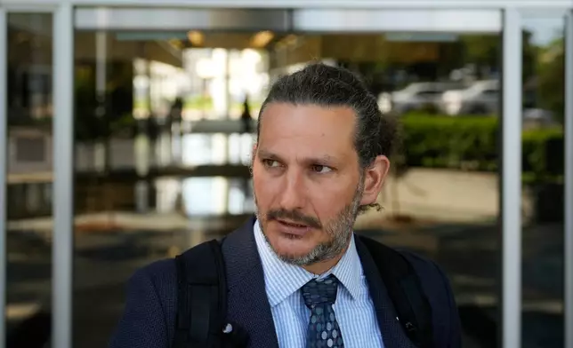 Attorney Judah Lakin is interviewed outside of Immigration Court Tuesday, May 12, 2026, in Concord, Calif. (AP Photo/Jeff Chiu)