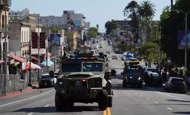 Law enforcement vehicles are seen near MacArthur Park after federal authorities made arrests on charges related to selling illicit drugs on Wednesday, May 6, 2026, in Los Angeles. (AP Photo/Jae C. Hong)