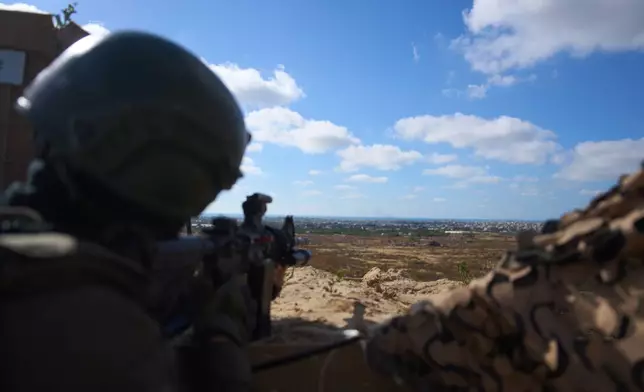 An Israeli soldier occupies a military position overlooking the so-called yellow line in the central Gaza Strip, Tuesday, May 26, 2026. (AP Photo/Ariel Schalit)