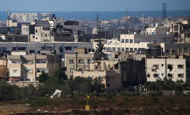 A yellow block noting part of the so-called yellow line that has separated the Gaza Strip's Israeli-held and Palestinian zones since the October ceasefire is visible in the central Gaza Strip, Tuesday, May 26, 2026. (AP Photo/Ariel Schalit)