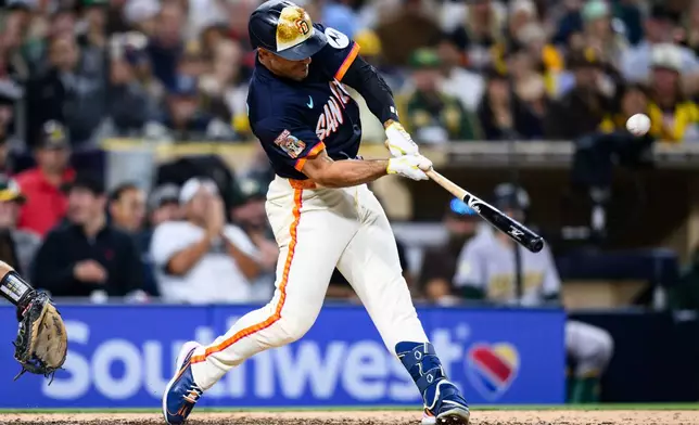San Diego Padres' Ramón Laureano hits a home run during the seventh inning of a baseball game against the Athletics, Friday, May 22, 2026, in San Diego. (AP Photo/William Liang)