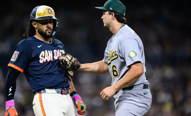 Athletics first baseman Nick Kurtz, right, tags out San Diego Padres' Fernando Tatis Jr., left, during the fifth inning of a baseball game Friday, May 22, 2026, in San Diego. (AP Photo/William Liang)