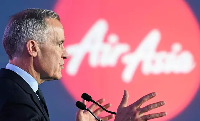 Canada's Prime Minister Mark Carney speaks during an event at the Airbus A220 Delivery Center in Mirabel, Que., Wednesday, May 6, 2026, where AirAsia placed a landmark order for 150 Airbus A220 aircraft. (Graham Hughes/The Canadian Press via AP)