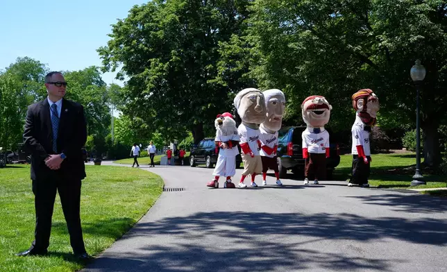 Mascots of the Washington Nationals baseball team stand near the south lawn of the White House, Tuesday, May 5, 2026, in Washington. (AP Photo/Jacquelyn Martin)
