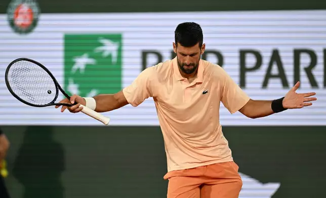 Novak Djokovic of Serbia celebrates after winning the first round men's singles tennis match against against Giovanni Mpetshi Perricard of France at the French Open tennis tournament in Paris, Sunday, May 24, 2026. (AP Photo/Emma Da Silva)