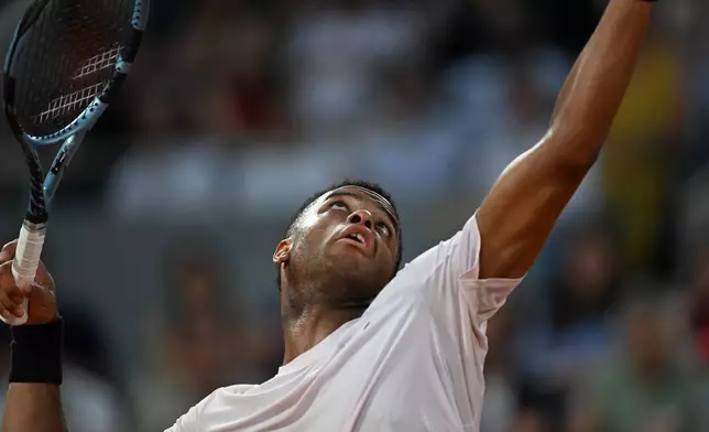 Giovanni Mpetshi Perricard of France serves to Novak Djokovic of Serbia during their first round men's singles tennis match at the French Open tennis tournament in Paris, Sunday, May 24, 2026. (AP Photo/Emma Da Silva)