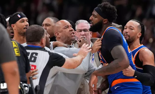 New York Knicks center Mitchell Robinson (23) and Atlanta Hawks guard Dyson Daniels (5) fight in the first half during Game 6 in a first-round NBA basketball playoffs series Thursday, April 30, 2026, in Atlanta. (AP Photo/Brynn Anderson)