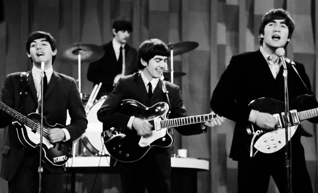 FILE - The Beatles, from left, Paul McCartney, Ringo Starr, George Harrison and John Lennon, perform for the CBS "Ed Sullivan Show" in New York, as they record a set on Feb. 9, 1964, that would be shown later on a broadcast of the show. (AP Photo/Dan Grossi, File)