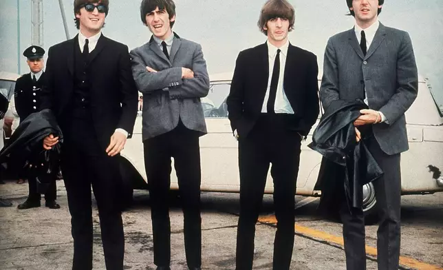 FILE - The Beatles, from left, John Lennon, George Harrison, Ringo Starr and Paul McCartney, arrive in Liverpool, England on July 10, 1964, for the premiere of their movie "A Hard Day's Night." (AP Photo, File)