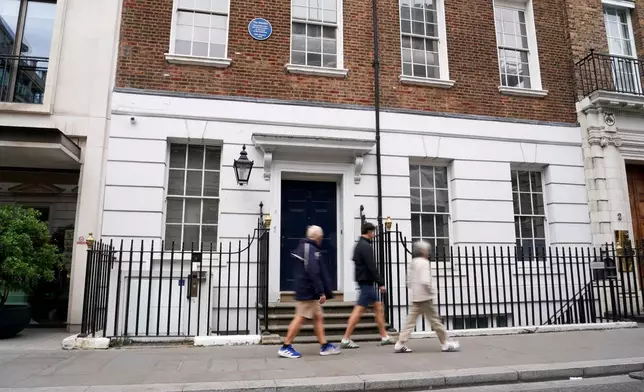 People walk past the building in Savile Row where The Beatles held their last ever concert as a band, which is due to be turned into a fan museum in 2027, in London, Sunday, May 10, 2026. (AP Photo/Alberto Pezzali)