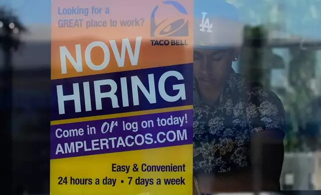 A hiring sign is displayed at a restaurant in Niles, Ill., Thursday, May 14, 2026. (AP Photo/Nam Y. Huh)