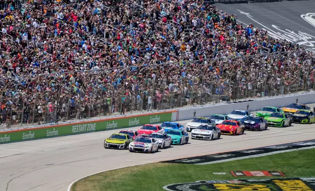 FILE - Carson Hocevar and William Byron lead the pack to start a NASCAR Cup Series auto race at Texas Motor Speedway in Fort Worth, Texas, May 4, 2025. (AP Photo/Gareth Patterson, File)