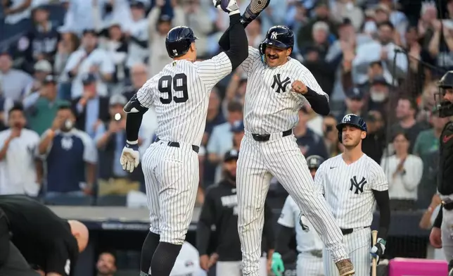 New York Yankees' Aaron Judge (99) celebrates with New York Yankees' Trent Grisham, center right, after hitting a two-run home run during the first inning of a baseball game against Baltimore Orioles, Monday, May 4, 2026, in New York. (AP Photo/Yuki Iwamura)