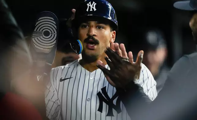 New York Yankees' Trent Grisham celebrates with teammates after scoring on a sacrifice fly hit by Yankees' Cody Bellinger during the third inning of a baseball game against Baltimore Orioles, Monday, May 4, 2026, in New York. (AP Photo/Yuki Iwamura)