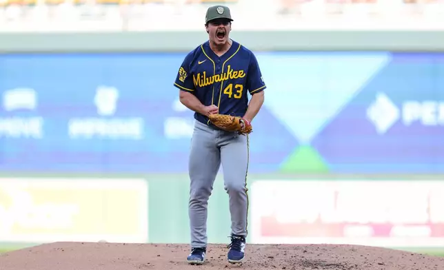 Milwaukee Brewers starting pitcher Logan Henderson celebrates after striking out Minnesota Twins' Austin Martin during the second inning of a baseball game Saturday, May 16, 2026, in Minneapolis. (AP Photo/Bailey Hillesheim)