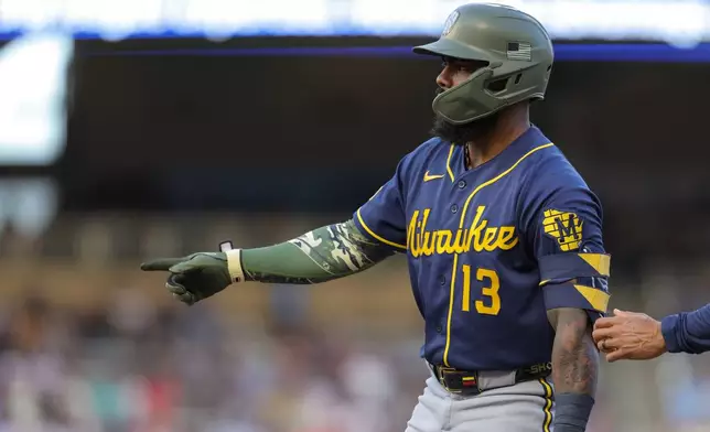 Milwaukee Brewers' Luis Rengifo celebrates after reaching first base on a fielding error by Minnesota Twins third baseman Royce Lewis during the fourth inning of a baseball game Saturday, May 16, 2026, in Minneapolis. (AP Photo/Bailey Hillesheim)