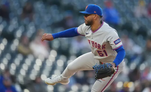 New York Mets starting pitcher Freddy Peralta works against the Colorado Rockies in the first inning of a baseball game, Wednesday, May 6, 2026, in Denver. (AP Photo/David Zalubowski)