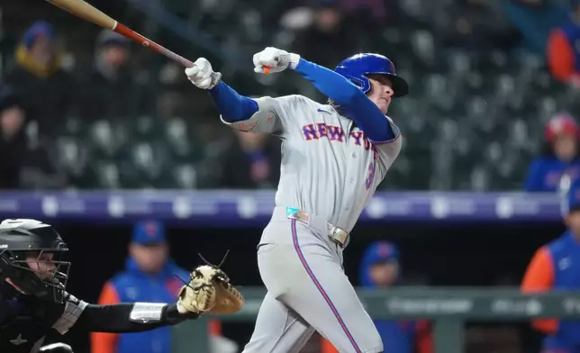 New York Mets' Carson Benge follows the flight of his single to drive in two runs off Colorado Rockies starting pitcher Michael Lorenzen in the fourth inning of a baseball game, Wednesday, May 6, 2026, in Denver. (AP Photo/David Zalubowski)