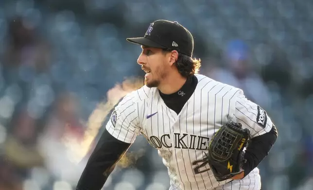 Colorado Rockies starting pitcher Michael Lorenzen works against the New York Mets in the first inning of a baseball game, Wednesday, May 6, 2026, in Denver. (AP Photo/David Zalubowski)
