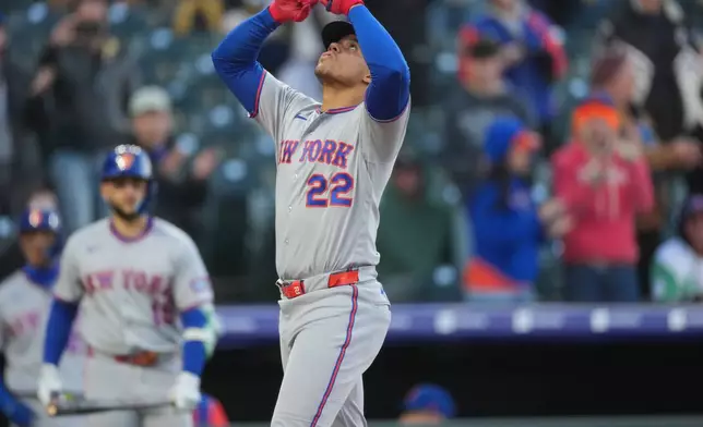 New York Mets' Juan Soto gestures as he crosses home plate after hitting a solo home run off Colorado Rockies starting pitcher Michael Lorenzen in the first inning of a baseball game, Wednesday, May 6, 2026, in Denver. (AP Photo/David Zalubowski)