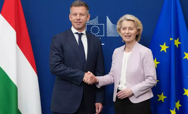 European Commission President Ursula von der Leyen, right, greets Hungary's Prime Minister Peter Magyar prior to a meeting at EU headquarters in Brussels, Friday, May 29, 2026. (AP Photo/Virginia Mayo)