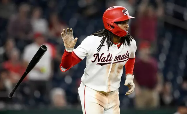 Washington Nationals' CJ Abrams tosses his bat as he watches his grand slam during the eighth inning of a baseball game against the Minnesota Twins, Wednesday, May 6, 2026, in Washington. (AP Photo/Nick Wass)