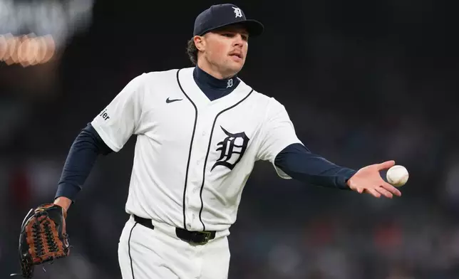 Detroit Tigers pitcher Brant Hurter tosses the ball to first base for an out on a Texas Rangers' Brandon Nimmo ground ball during the fifth inning of a baseball game Sunday, May 3, 2026, in Detroit. (AP Photo/Paul Sancya)