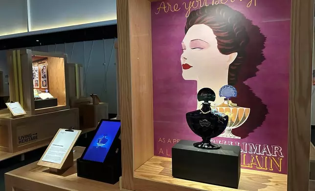 An advertisement from 1935 and a midnight-blue perfume bottle for Jacques Guerlain's Shalimar fragrance pictured on are display as part of the Comite Colbert "Hidden Treasures" exhibit at The Shed on Tuesday, May 26, 2026, in New York. (AP Photo/Beatrice Dupuy)
