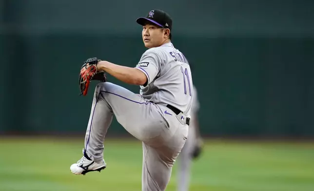 Colorado Rockies starting pitcher Tomoyuki Sugano, of Japan, warms up during the first inning of a baseball game against the Arizona Diamondbacks, Friday, May 22, 2026, in Phoenix. (AP Photo/Ross D. Franklin)