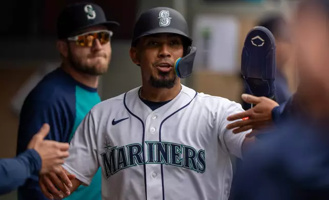 Seattle Mariners' Jhonny Pereda celebrates in the dugout after scoring a run during third inning of a baseball game against the Atlanta Braves, Wednesday, May 6, 2026, in Seattle. (AP Photo/Stephen Brashear)