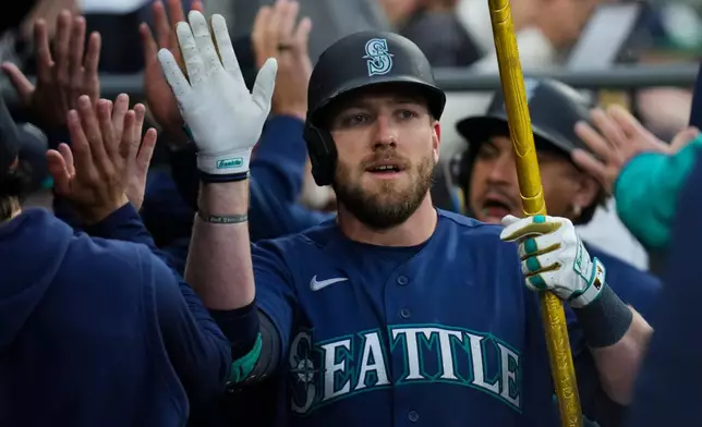 Seattle Mariners' Luke Raley celebrates after hitting a grand slam during the third inning of a baseball game against the Chicago White Sox, Friday, May 8, 2026, in Chicago. (AP Photo/Erin Hooley)