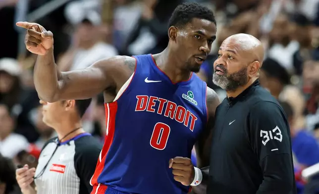 Detroit Pistons center Jalen Duren (0) talks with head coach J.B. Bickerstaff during the first half in Game 7 of a second-round NBA playoffs basketball series Sunday, May 17, 2026, in Detroit. (AP Photo/Duane Burleson)