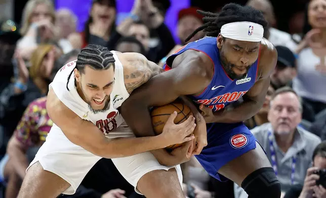 Cleveland Cavaliers guard Jaylon Tyson, left, and Detroit Pistons forward Isaiah Stewart fight over a ball during the first half in Game 5 of a second-round NBA playoffs basketball series, Wednesday, May 13, 2026, in Detroit. (AP Photo/Duane Burleson)