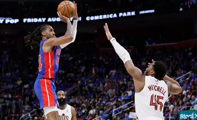 Detroit Pistons guard Daniss Jenkins, left, takes a jump shot against Cleveland Cavaliers guard Donovan Mitchell (45) during the first half in Game 5 of a second-round NBA playoffs basketball series Wednesday, May 13, 2026, in Detroit. (AP Photo/Duane Burleson)