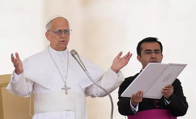Pope Leo XIV, flanked by his secretary Edgard Ivan Rimaycuna Inga, delivers his blessing at the end of his weekly general audience in St. Peter's Square, at the Vatican, Wednesday, May 13, 2026. (AP Photo/Alessandra Tarantino)