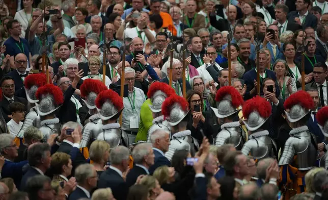 New Pontifical Swiss Guards attend a swearing-in ceremony in the Paul VI Hall at the Vatican, Wednesday, May 6, 2026. (AP Photo/Andrew Medichini)