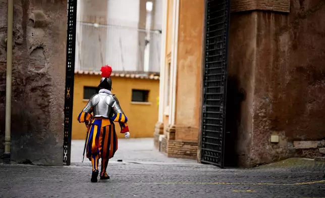 A Pontifical Swiss Guards marches ahead of a swearing in ceremony, at the Vatican, Wednesday, May 6, 2026. (AP Photo/Andrew Medichini)