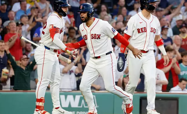 Boston Red Sox Isiah Kiner-Falefa, center, celebrates with teammates Wilyer Abreu, left, and Marcelo Mayer (11) after scoring on a single by Ceddanne Rafaela during the fourth inning of a baseball game against the Atlanta Braves, Wednesday, May 27, 2026, in Boston. (AP Photo/Mary Schwalm)