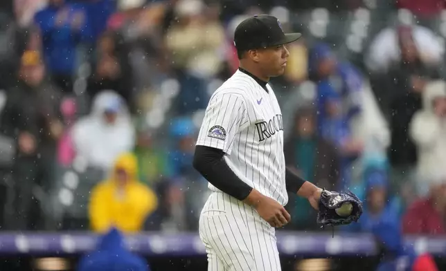 Colorado Rockies relief pitcher Juan Mejia reacts after giving up the go-ahead run to Texas Rangers' Josh Jung on an RBI single in the ninth inning of a baseball game Wednesday, May 20, 2026, in Denver. (AP Photo/David Zalubowski)