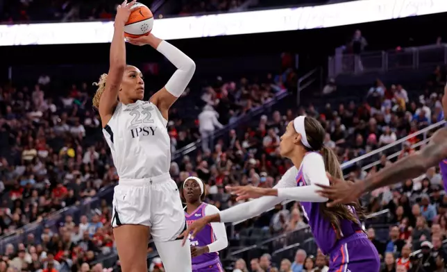 Las Vegas Aces center A'ja Wilson (22) looks to shoot over Phoenix Mercury forward/guard DeWanna Bonner, right, during the first half of an WNBA basketball game Saturday, May 9, 2026, in Las Vegas. (Steve Marcus/Las Vegas Sun via AP)