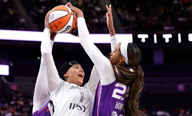 Phoenix Mercury forward/guard DeWanna Bonner, right, blocks a shot by Las Vegas Aces forward Kierstan Bell (1) during the first half of an WNBA basketball game Saturday, May 9, 2026, in Las Vegas. (Steve Marcus/Las Vegas Sun via AP)