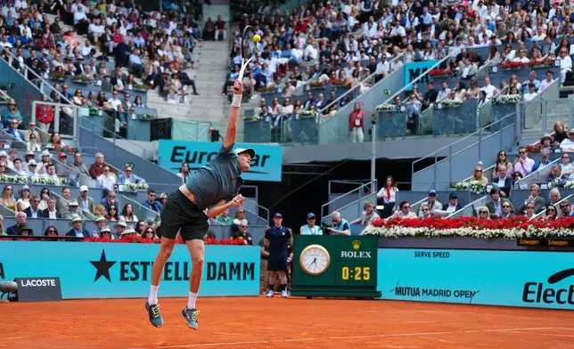 Jannik Sinner, of Italy, serves the ball to Alexander Zverev, of Germany, during their men's singles tennis final match at the Madrid Open tennis tournament in Madrid, Spain, Sunday, May 3, 2026. (AP Photo/Manu Fernandez)
